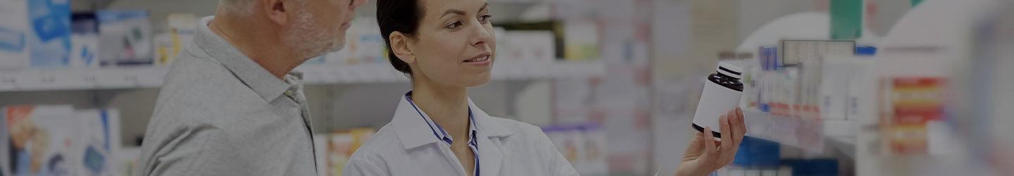 Pharmacy worker helping a client find medicine at a pharmacy